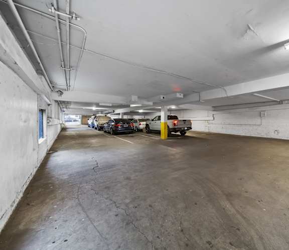 A parking garage with a concrete floor and white walls.