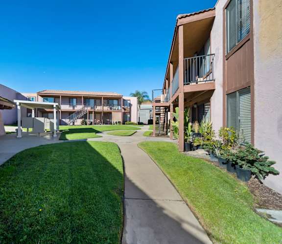 A sunny day at a residential complex with a clear blue sky.