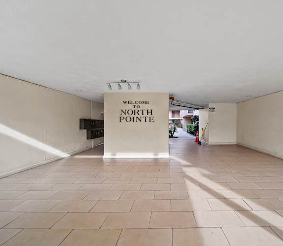 A sign that says "Welcome to North Pointe" hangs from the ceiling in a spacious room with tiled floors.