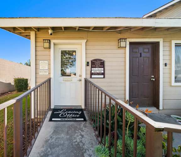 A house with a white door and a sign that says "Loving Wife".
