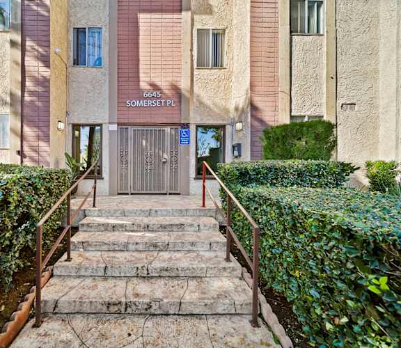 The image shows a building entrance with a sign that reads "6645 SOMERSET PL".