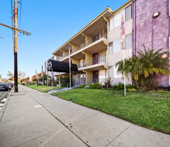 A purple building with a flag on the balcony.
