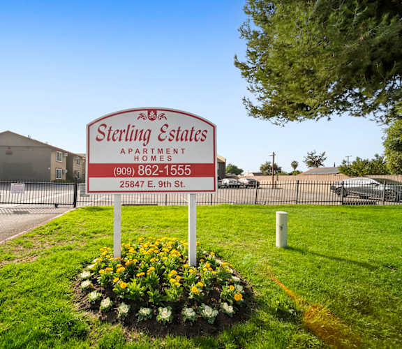 A Sterling Estates Apartments sign is in front of a building.