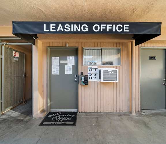 A leasing office with a sign on the door.