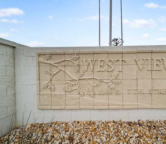 A stone plaque on a wall that says West View.