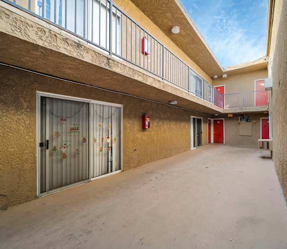 A long hallway with a fire extinguisher on the wall.