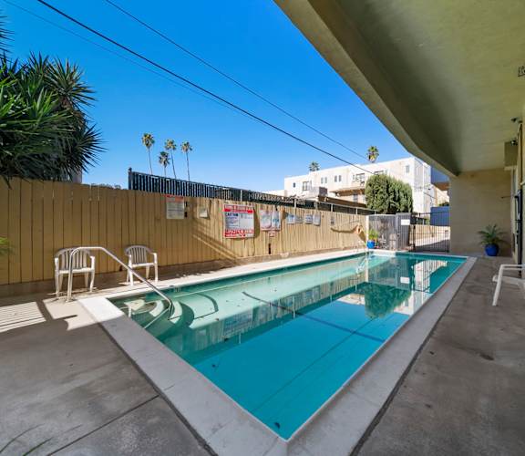 A small pool with a concrete floor and a concrete wall.