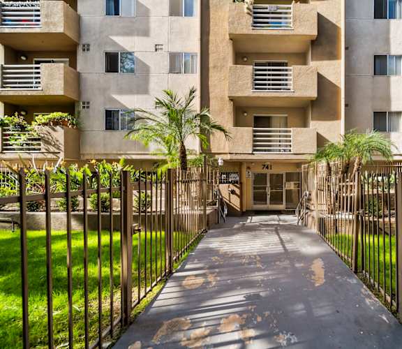 A concrete building with a gate in front of it.