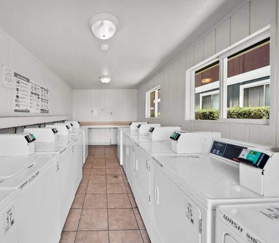 A laundromat with rows of washing machines.