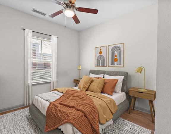 a bedroom with a bed and a ceiling fan