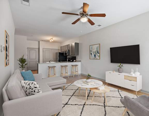 a living room with a couch and a ceiling fan