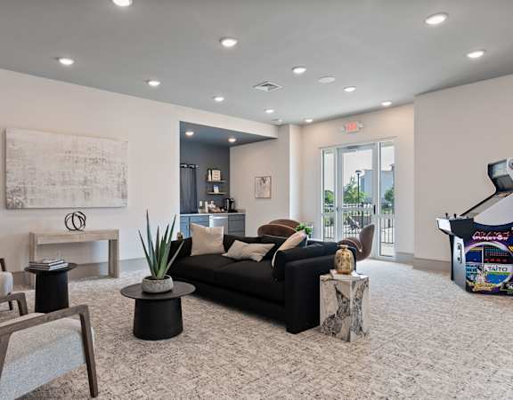 a living room with a couch and chairs and a piano
