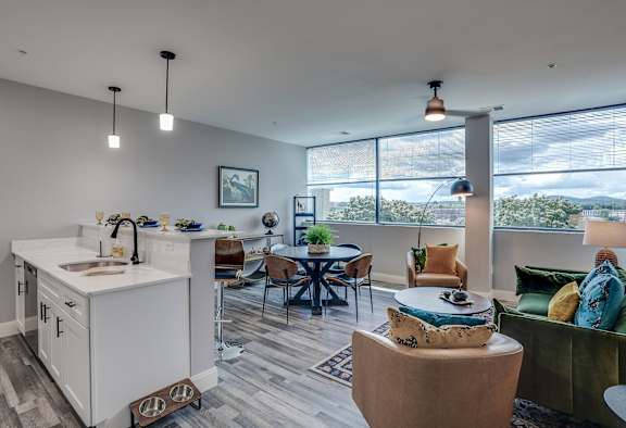 an open living room with a kitchen and a dining room