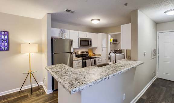 a kitchen with a granite counter top and stainless steel appliances