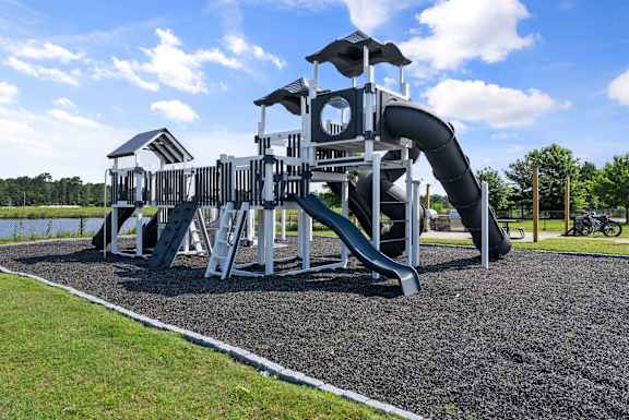 a playground with a large slide in a park