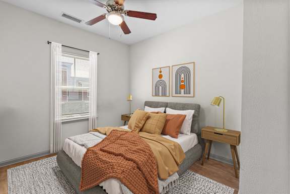 a bedroom with a bed and a ceiling fan