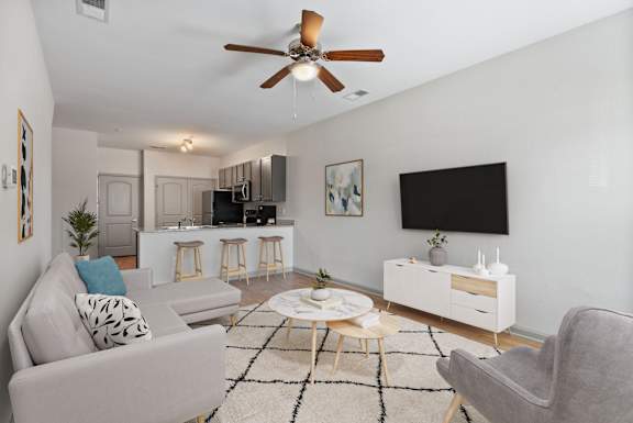 a living room with a couch and a ceiling fan