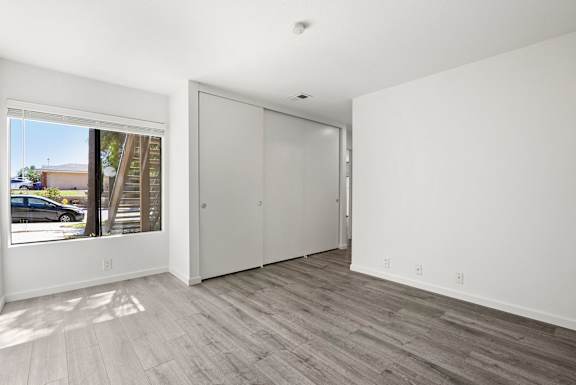 a living room with a large window and white walls