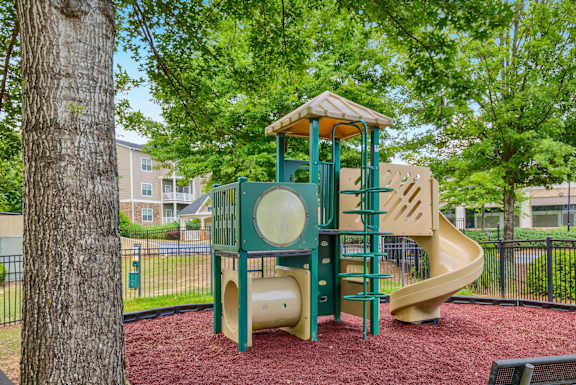a playground with a jungle gym and a slide