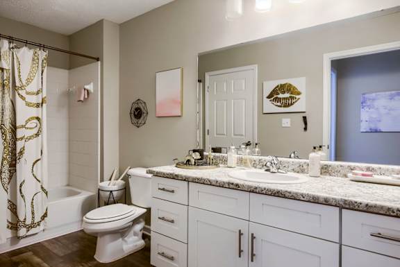 a bathroom with a white toilet next to a white sink