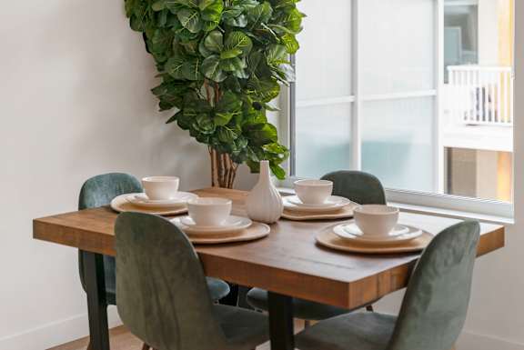 a dining room with a table and chairs and a window