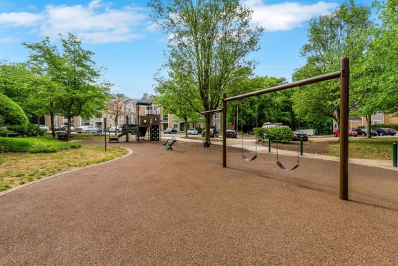 a park with swings and a playground on a sunny day