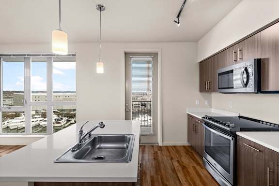 A modern kitchen with a view of the city.