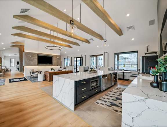 the kitchen is open to the living room and dining room at The BLVD at Wilson Crossings, Wyoming, MI