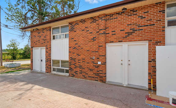 A building with a blue wall and a white door.