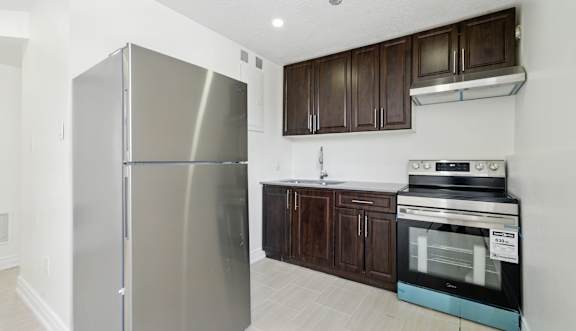 A kitchen with white cabinets and stainless steel appliances.
