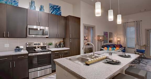 a kitchen with stainless steel appliances and granite counter tops