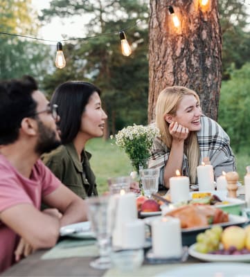 a group of people sitting around a table talking