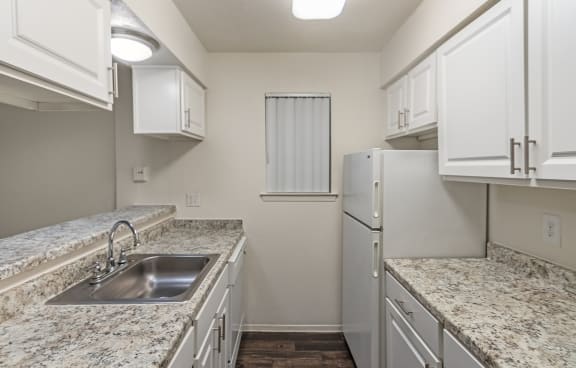 This is a photo of the kitchen in the 558 square foot 1 bedroom apartment at The Summit at Midtown Apartments in Dallas, TX.