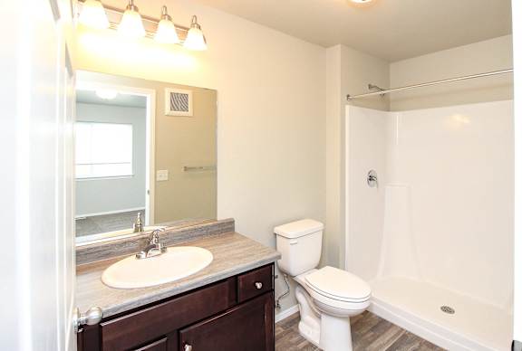 A white toilet sits next to a sink in a bathroom.