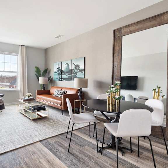an open concept living room and dining area with a white dining table and rattan chairs at Hillside Club Apartments, Livingston, NJ, 07039