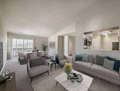 A living room with a grey couch, a coffee table, and a large window at The Apartments at Owings Run, Owings Mills, 21117