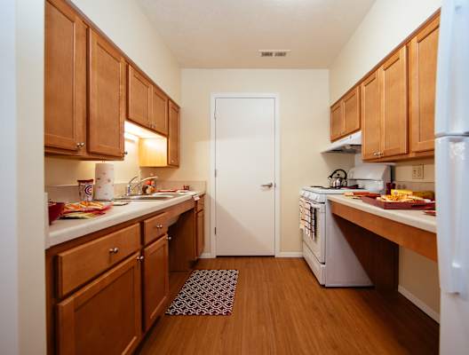 A kitchen with wooden cabinets and a white refrigerator.