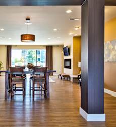 A large open dining room with a wooden table and chairs.
