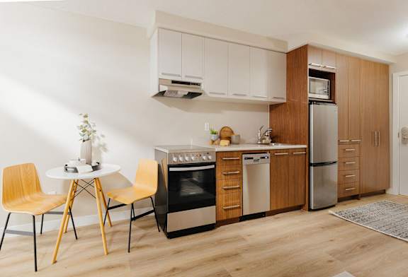 a kitchen with a table and chairs and a refrigerator