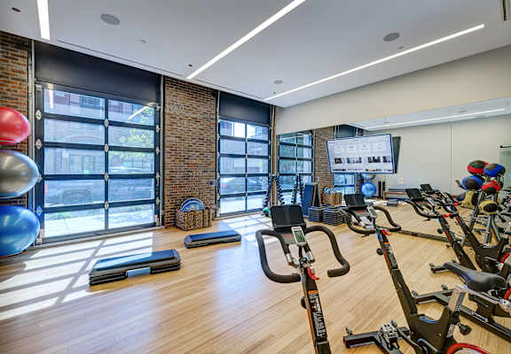 A gym with a brick wall and wooden floors. at The Mason Apartments, Illinois, 60607