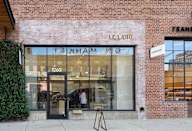 A brick building with a glass door and a sign that says "LE LABO".