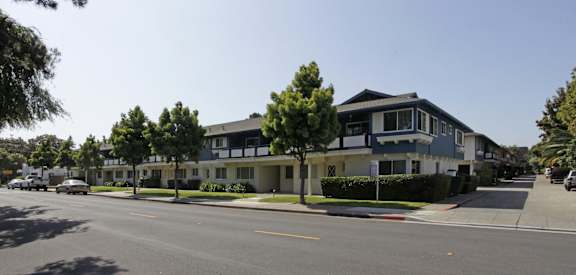 a row of houses on the corner of a street