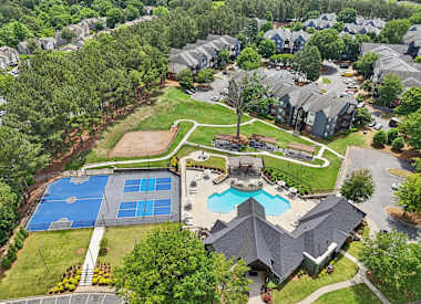 Wesley St. Claire Apartments at Lawrenceville amenity area with pool and tennis courts - Lawrenceville, GA
