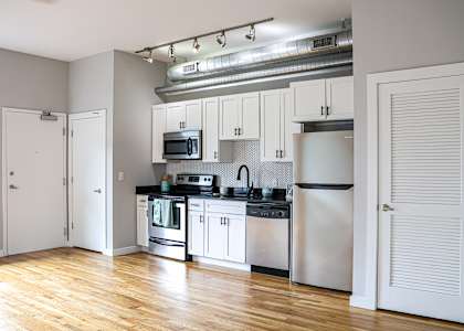 A kitchen with white cabinets and stainless steel appliances.