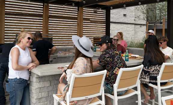 A group of people are gathered around a bar area.