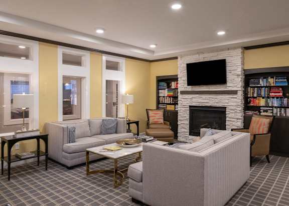 a living room with couches and chairs and a fireplace