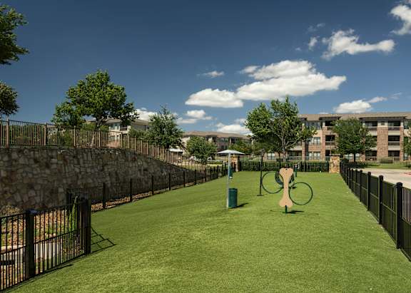 A playground with a green slide and a yellow slide.
