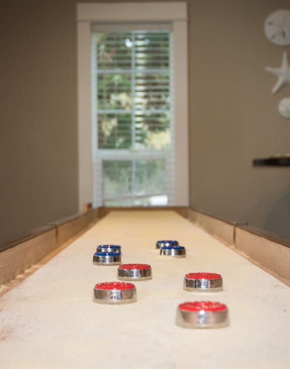 Shuffleboard table and pucks at Stillwater apartments 