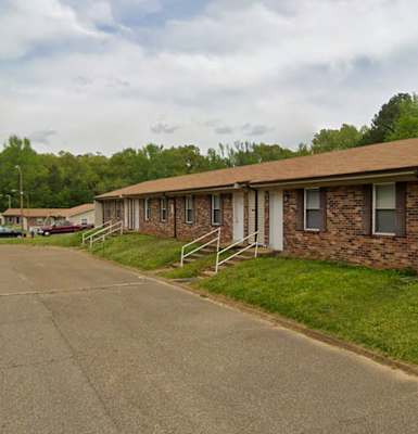 A building with a brown roof and a white garage door.