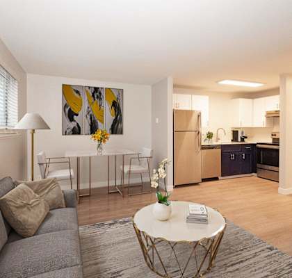 A living room with a grey couch and a white coffee table at Aspenridge Apartments, Vancouver, WA